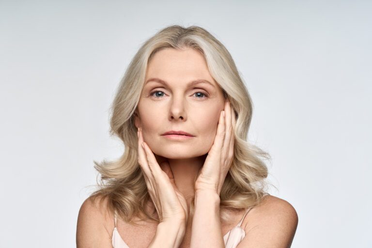 Older woman touching her perfect skin.